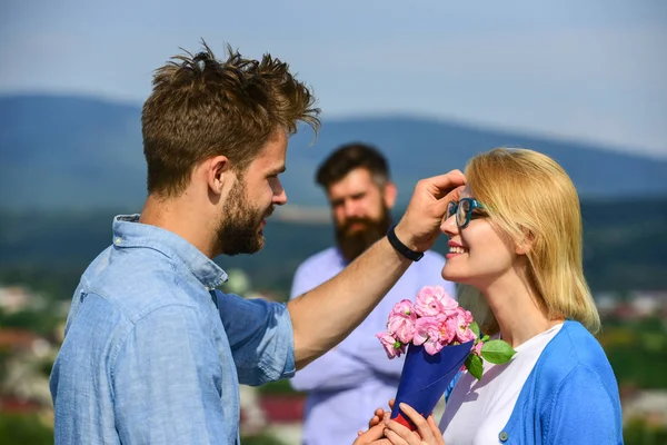 Couple in love dating while jealous husband fixedly watching on background. Unrequited love concept. Lovers meeting outdoor flirt romance relations. Couple romantic date lover present bouquet flowers — Stock Photo, Image