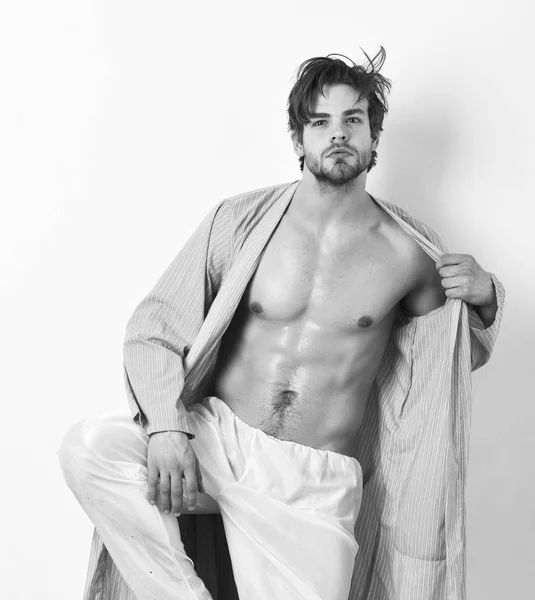 Fit guy with torso and six packs stands in blue bathrobe. Macho or athlete with sexy body in leisure clothes. — Stock Photo, Image