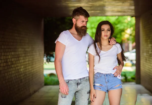 Couple hang out in porch or underground crossing. Couple in love cuddling in porch. Girl attractive brunette and bearded hipster man relaxing hang out underground crossing or subway. Underground date