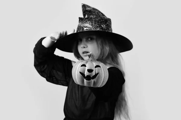 Kid in black witch hat, dress and serious face — Stock Photo, Image