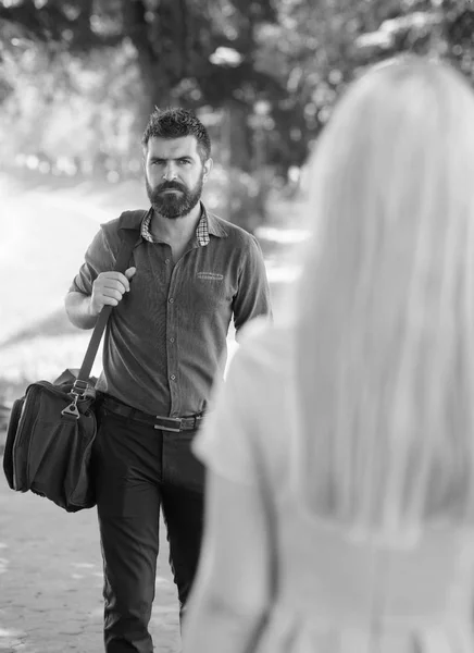 Meet on sunny summer day, nature background, defocused. Casual encounter, acquaintance, start of relations. First meet of strangers