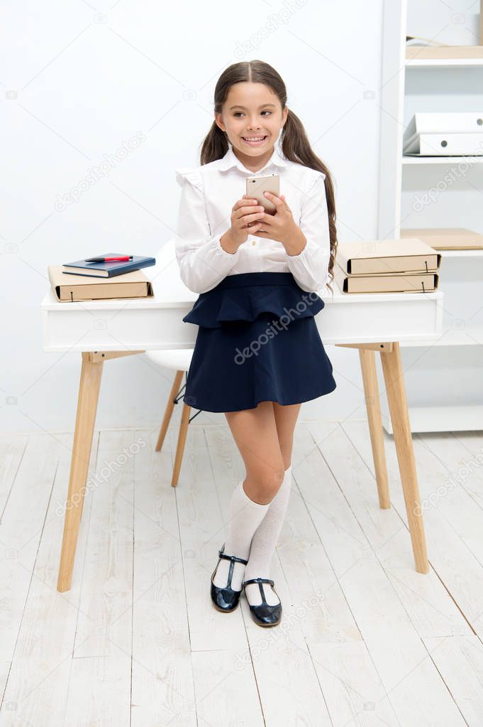 Always in touch. Kid girl send message to parents. Schoolgirl awkward smiling face has bad news. Girl nervous informing parents about bad marks in school. Awkward about fail or mistake