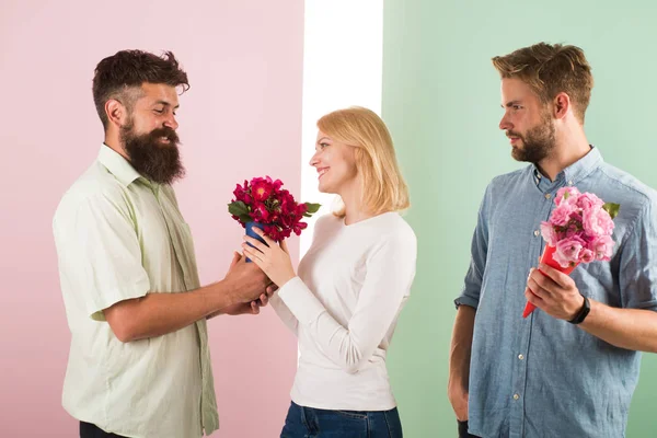 Men competitors with bouquets flowers try conquer girl. Girl smiling made her choice. Broken heart concept. Woman happy takes bouquet flowers romantic gift. Girl popular receive lot male attention — Stock Photo, Image