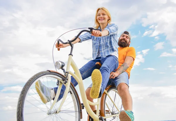 Couple with bicycle romantic date sky background. Couple in love date cycling. Explore city. Man and woman rent bike to discover city as tourist. Bike rental or bike hire for short periods of time