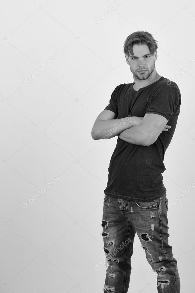 Macho with confident face and crossed arms, copy space. Man with fair hair on white background. Masculinity and confidence