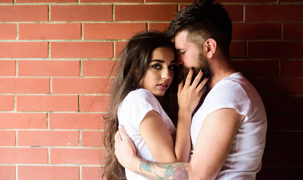 Moments of intimacy. Couple in love hugs brick wall background. Couple find place to be alone. Couple enjoy intimacy cuddling without witnesses. Girl and hipster romantic date intimacy moment