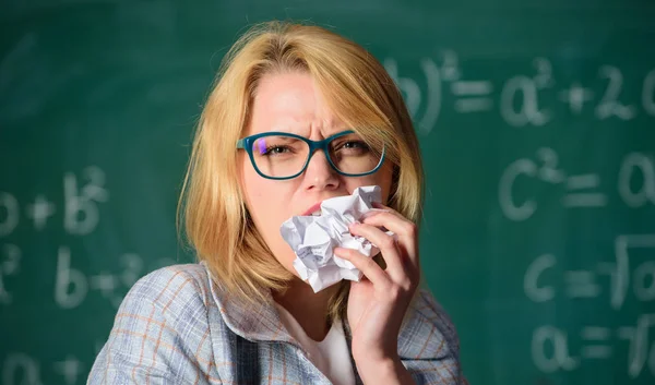Thirst of knowledge. Hungry for knowledge. She ready to eat her paperwork. Teacher eats piece of paper with mistake failed test. Woman teacher eats crumpled piece of paper chalkboard background — Stock Photo, Image