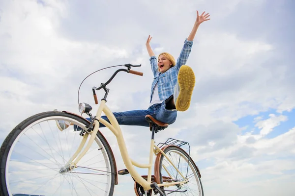 Mulher se sente feliz enquanto aprecia ciclismo. Menina passeios de bicicleta céu fundo. Como o ciclismo muda sua vida e faz você feliz. Razões para andar de bicicleta. Benefícios à saúde mental. Pedalando para a felicidade — Fotografia de Stock