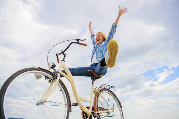 Woman feels happy while enjoy cycling. Girl rides bicycle sky background. How cycling changes your life and make you happy. Reasons to ride bicycle. Mental health benefits. Pedaling towards happiness