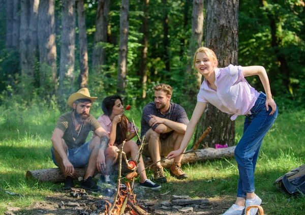 Picnic with friends in forest near bonfire. Company friends having hike picnic nature background. Hikers relaxing during snack time. Tourists hikers relaxing while having picnic snack. Summer picnic