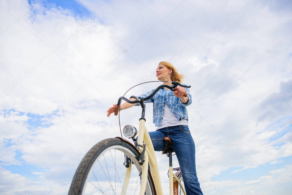 Promoting cycling infrastructure. Girl rides bike sky background. Girl happy face likes ride bike. Bicycle transportation eco friendly, cheap and fast way. Cycling culture and infrastructure