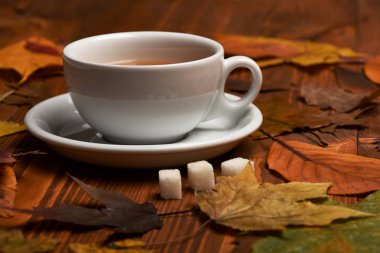 Tahta zemin üzerinde şeker küpleri olan sıcak içecek..