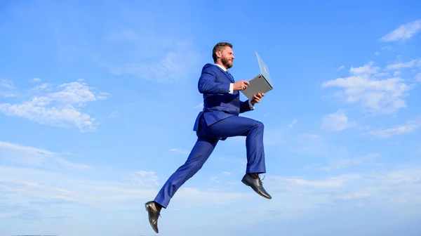 Excellent internet provider raise up quality connection. Internet connection so fast. Boost speed online. Businessman laptop satisfied quality. Man with laptop jump or fly in air blue sky background.