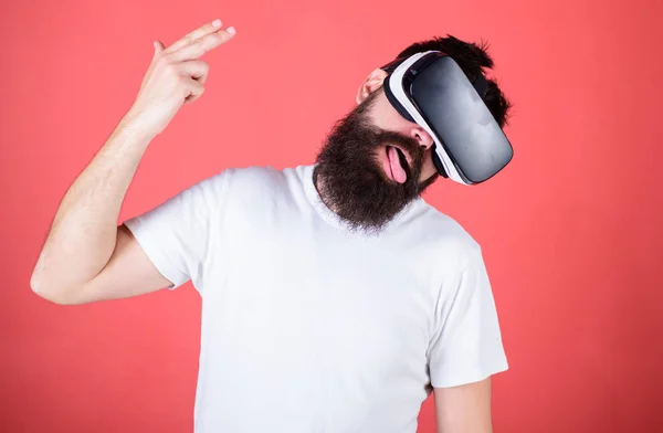 First person shooter shows how addictive VR could be. Suicide shot game. Man hand gesture as gun play shooter game in VR glasses. Man bearded hipster with virtual reality headset on red background — Stock Photo, Image
