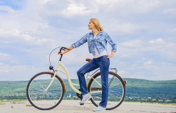 Girl ride cruiser bicycle. Health benefits of cycling. Reasons to ride bike. Woman rides bicycle sky background. Increase muscle strength and flexibility by riding bike. Benefits of cycling every day