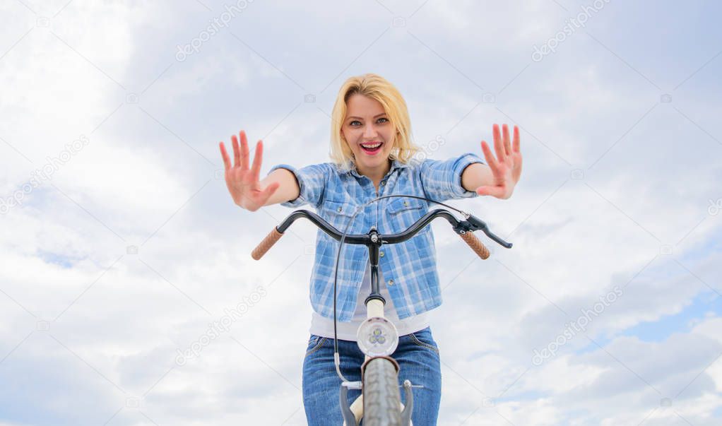 Check it out. Bicycle tricks. Woman likes to ride bike. Can everyday bicycling make you happier. Bicycling her hobby and best way to relax and reduce stress. Girl can ride her bike with no handlebars
