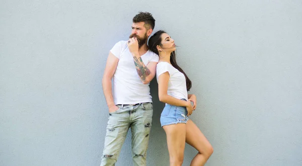 Couple stylish young modern people. Couple in love hang out together grey wall background. Couple white shirts lean each other. Hipster bearded and stylish girl hang out outdoors. Urban loving couple — Stock Photo, Image