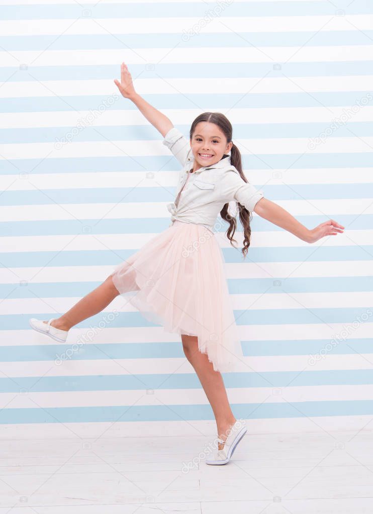 Child concept. Happy little child dancing. Child girl smile in fashion dress. Child and childhood. sense of freedom
