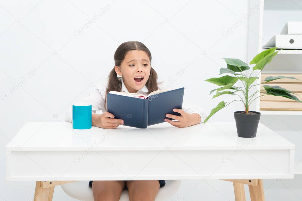 Learning at home. Little girl do not want learning at home. Cute child learning at home. Schoolgirl learning at home