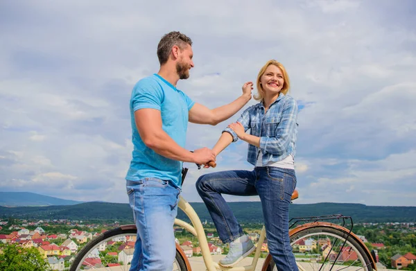 How to meet girls while riding bike. Man with beard and shy blonde lady on first date. Couple just meet to become acquainted. Woman feels shy in company with attractive macho. Picking up girl