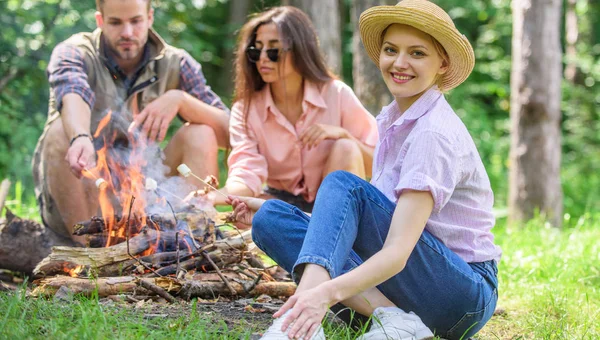 Passar um bom tempo no fim de semana. Assar marshmallows atividade de grupo popular em torno da fogueira. Jovens no piquenique a assar marshmallows. Empresa amigos preparar assado marshmallows lanche natureza fundo — Fotografia de Stock