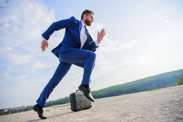 Man concentrated focused on business achievement. Businessman formal suit run outdoors blue sky background. Business as marathon or sprint. Entrepreneur run for success. Towards success