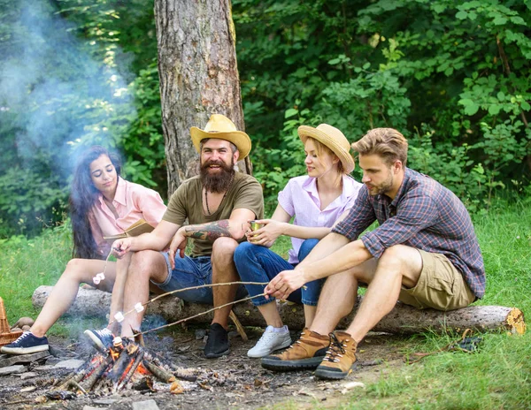 Best friends spend leisure weekend hike barbecue forest nature background. Company friends picnic or barbecue near bonfire. Roasting marshmallows barbecue. Friends enjoy weekend barbecue in forest — Stock Photo, Image