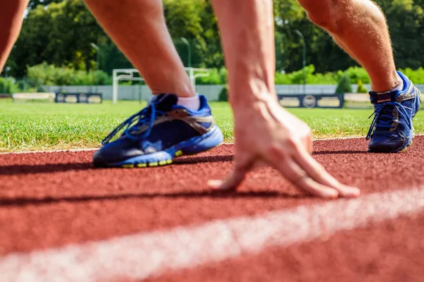 Starting point. Runner ready to go close up. Ready steady go concept. At the beginning of great sport career. Hand touch track path close up. Hand of sportsman on running track low start position — Stock Photo, Image
