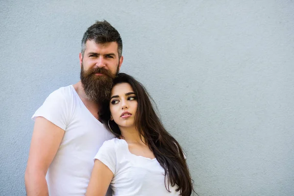 Romantic couple. Couple white shirt cuddle each other. Hipster bearded and stylish girl hang out urban romantic date. Couple stylish youth. Couple in love hang out together grey background copy space