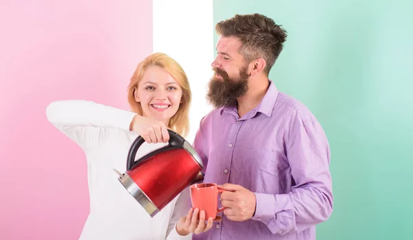 Prepare drink in minutes. Modern technology make life easier. Save time modern technology. Starting day together. Couple prepare morning drink electric kettle. Electric kettle boils water quickly — Stock Photo, Image