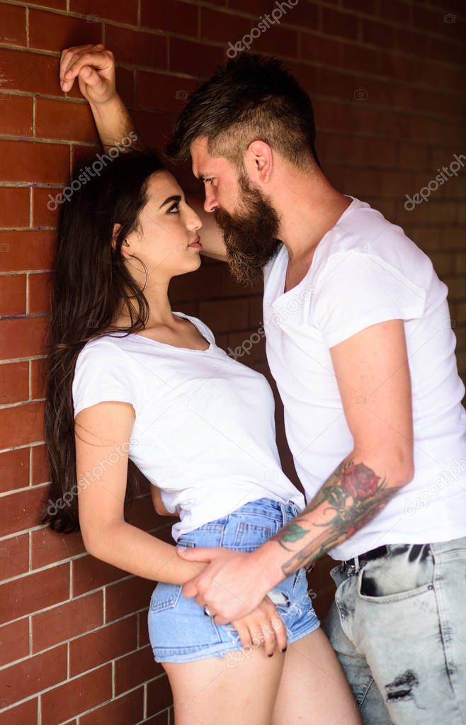 No rules for them. Couple in love full of desire brick wall background. Couple find place to be alone. Couple enjoy intimacy without witnesses public place. Girl and hipster full of desire cuddling