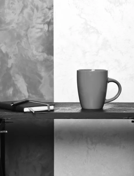 Tazza di tè o caffè rosso o tazza di ceramica per bere copybook e penna vassoio nero su sfondo marrone e beige testurizzato, spazio copia . — Foto Stock
