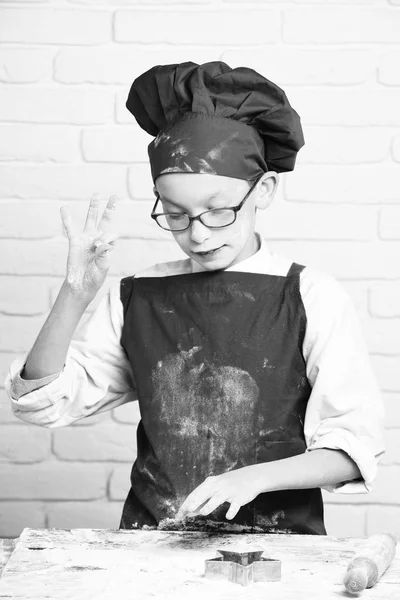 cooking on white brick wall background. stained cute cook chef boy