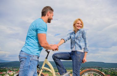 Rolling romance or bike date. Man with beard and shy blonde girl on first date. Woman feels shy in company with attractive macho. Couple just meet to hang out together. asual acquaintance concept clipart