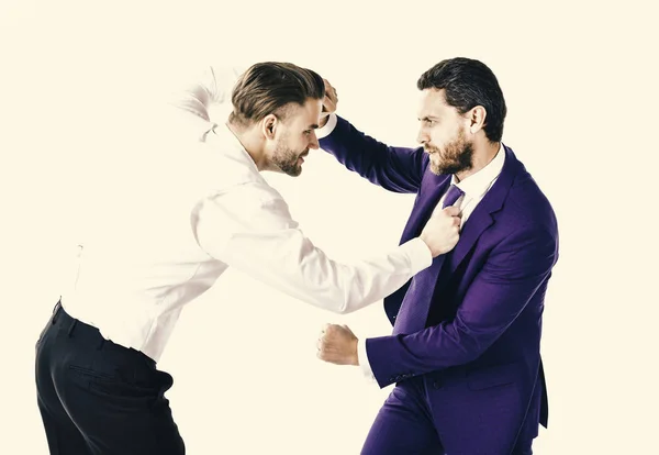 Businessmen fighting at workplace. Business conflict concept. Young men in formal wear or businessm