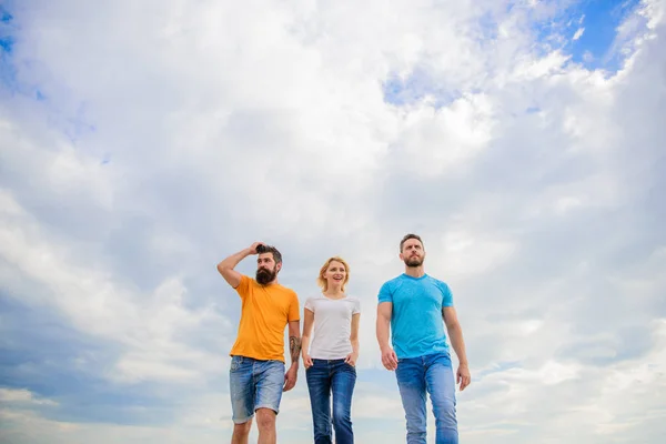 True friendship grow with destiny obstacles. United threesome true friends. Keep moving trough long way. United group purposefully moves forward. Men and woman walks dramatic cloudy sky background — Stock Photo, Image