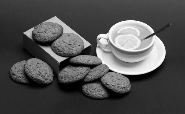 Oatmeal biscuits as pastry for cup of tea with lemon — Stock Photo, Image