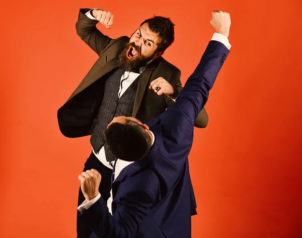 Men with beards fight on red background.