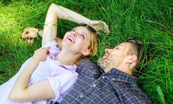 Couple in love relaxing lay at meadow. Nature fills them with freshness and peace. Man unshaven and girl lay on grass meadow. Guy and girl happy carefree enjoy freshness of grass. Closer to nature — Stock Photo, Image