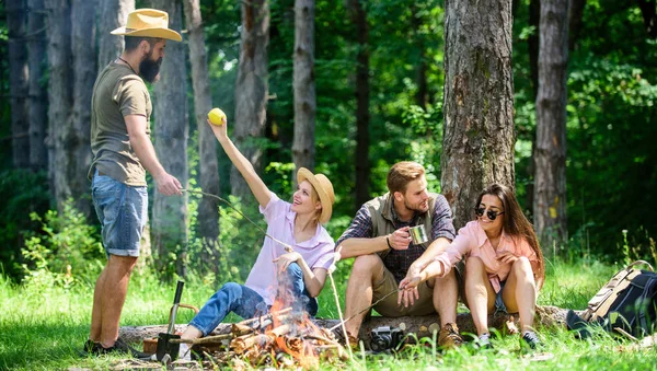 Camping and hiking. Company friends relaxing and having snack picnic nature background. Great weekend in nature. Halt for snack during hiking. Company hikers relaxing at picnic forest background