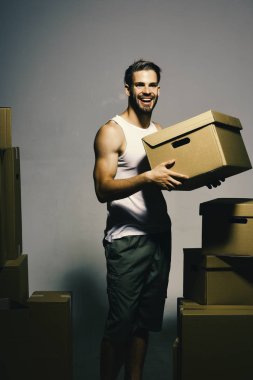 Gülen yüzlü maço beyaz tişört ve şort giyiyor.