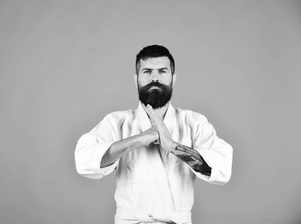 Karate man with serious face in uniform. Man with beard — Stock Photo, Image