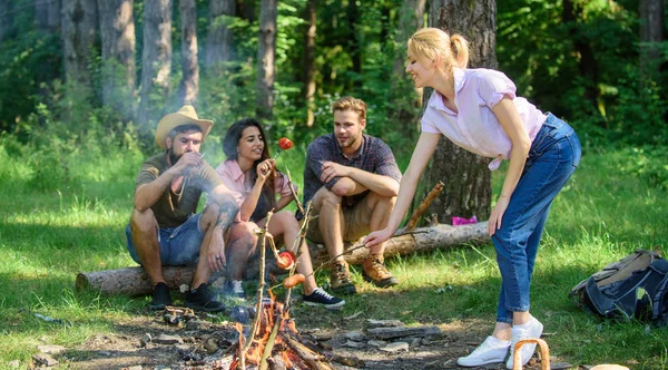 Picnic with friends in forest near bonfire. Company friends having hike picnic nature background. Summer picnic. Hikers relaxing during snack time. Tourists hikers relaxing while having picnic snack