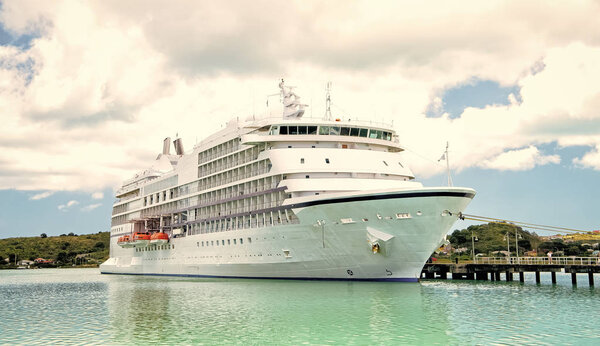 big cruise ship, white luxury yacht in sea port, Antigua