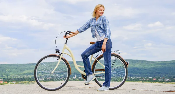 Woman rides bicycle sky background. Benefits of cycling every day. Keep fit shape easy with regular cycling. Girl ride cruiser bicycle. Health benefits of regular cycling. Reasons to ride bike