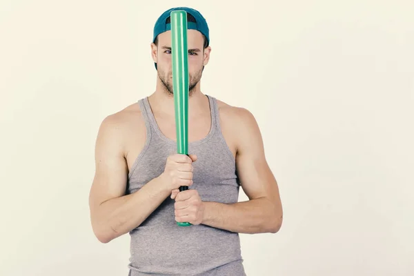 Guy in grey tank top holds bright green bat