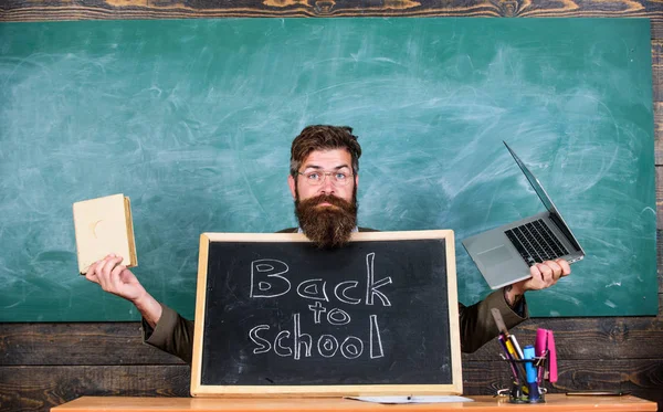 Teacher welcomes new pupils enter educational institution. Teacher or school principal welcomes with blackboard inscription back to school. Come to us. Private school advertising to boost enrollments