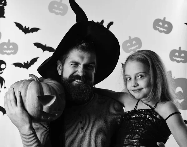 Father and daughter in costumes. Wizard and little witch