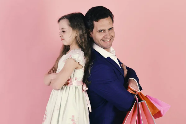 Schoolgirl and dad do shopping. Daughter and dad buy presents