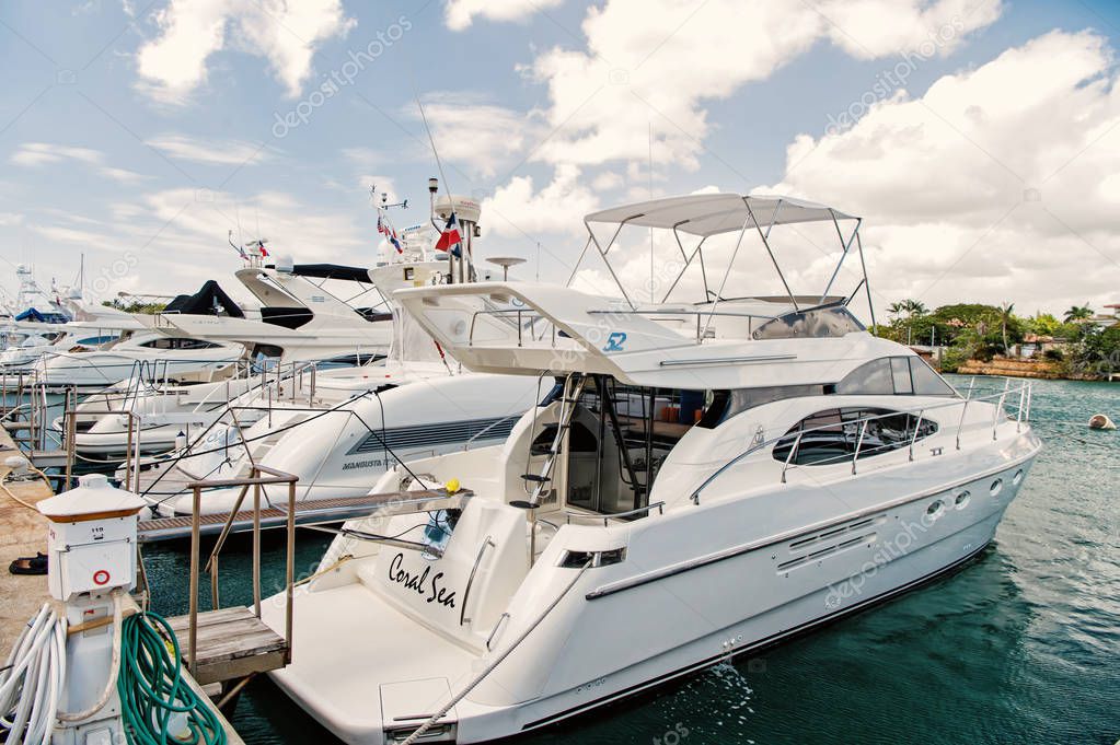 luxury yachts docked in the port in bay at sunny day with clouds on blue sky in La Romana, Dominican Republic